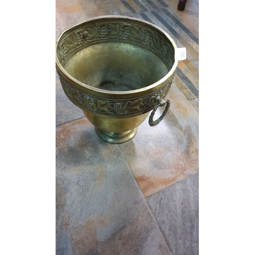 194 - Antique brass planter with intricate grapevine and leaf motif around the rim, featuring detailed sid... 