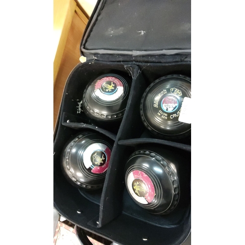 195 - Set of four Almark Crusader lawn bowls in a protective carrying case. Each bowl displays Almark bran... 