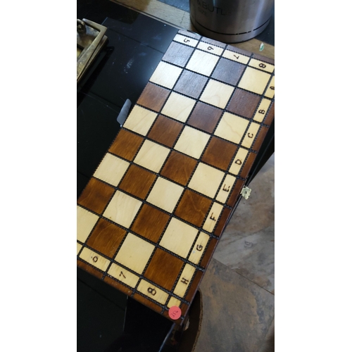 213 - Vintage wooden chess set with unique hand-carved pieces and foldable inlaid wood board. Comes with a... 