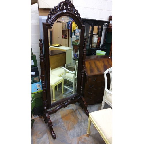 230 - Victorian mahogany cheval mirror with intricately carved crest and turned supports. Features an eleg... 