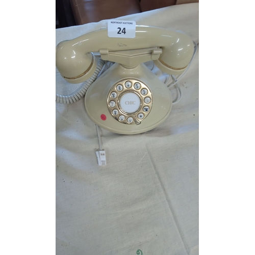 24 - Vintage rotary phone in beige with gold-tone accents.