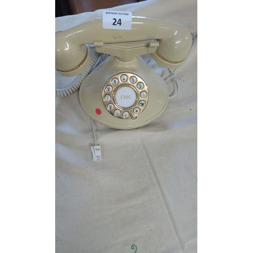 24 - Vintage rotary phone in beige with gold-tone accents.