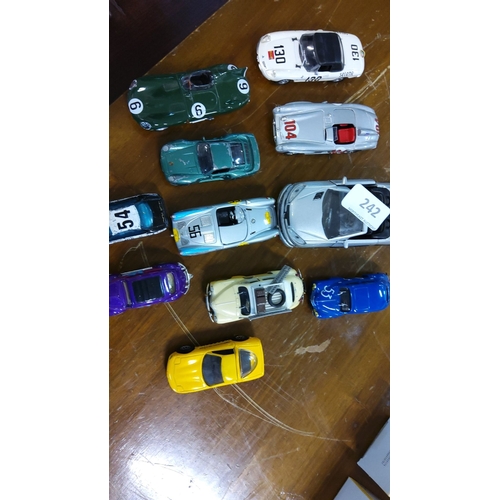 242 - Collection of 11 vintage die-cast model cars. There are various styles and colors, including racecar... 