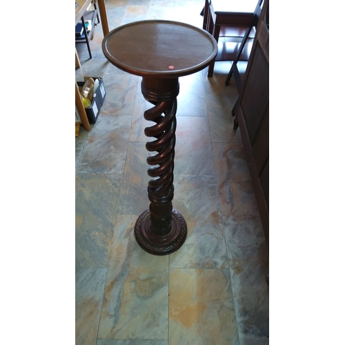 251 - Twisted mahogany plant stand from the Victorian-era. Features a circular top and an intricately carv... 