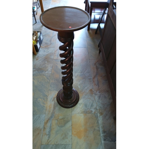 251 - Twisted mahogany plant stand from the Victorian-era. Features a circular top and an intricately carv... 