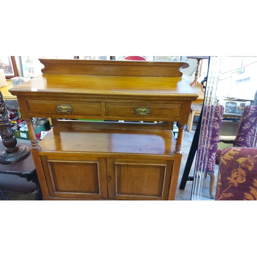 252 - Antique oak sideboard featuring a raised back, two drawers, turned supports, and lower cupboard stor... 