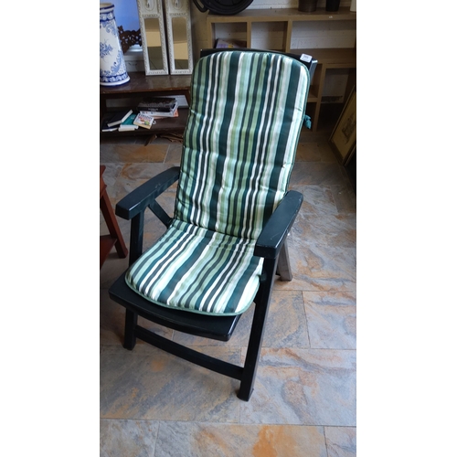 255 - Green and white striped cushioned chair.