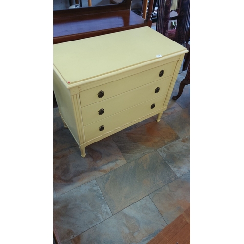 258 - Vintage chest of drawers, painted yellow. It has three deep drawers with ornate bronze drawer pulls.... 