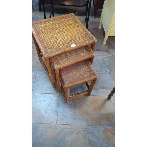 260 - Set of three nesting tables with woven rattan tops and bamboo frames, showcasing a natural finish.