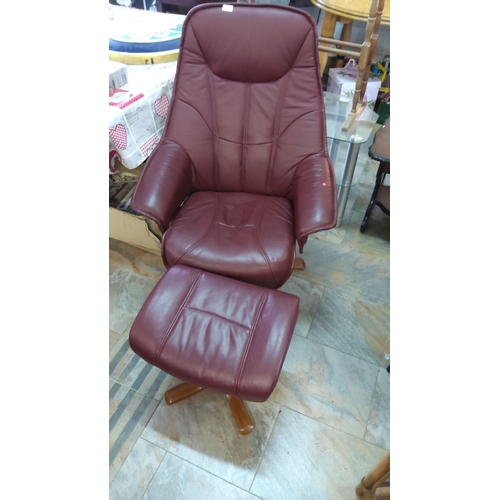 261 - Red leather recliner chair with matching ottoman, featuring wooden base and ergonomic design.