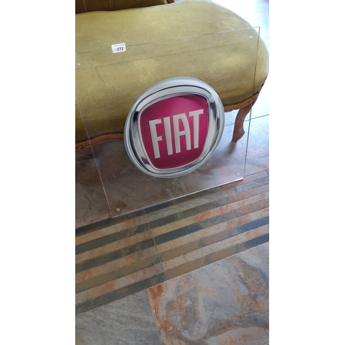 272 - Fiat logo encased in a clear acrylic panel. Measures approximately 56 cm x 56 cm.