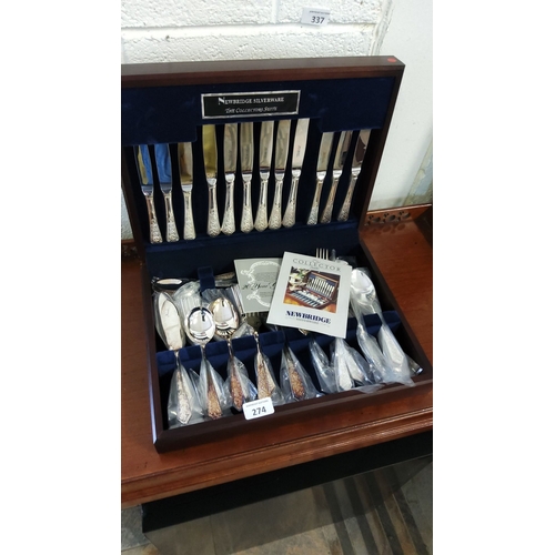 274 - Newbridge Silverware cutlery set includes knives, forks, spoons, and serving pieces in a presentatio... 