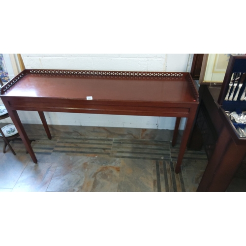 275 - Mahogany console table with a perforated decorative gallery rail and straight legs. Dimensions: appr... 