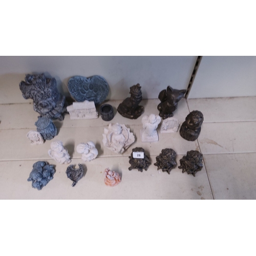 28 - Assorted small decorative concrete statues, featuring animal figures, cherubic angels, and various m... 