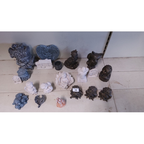 28 - Assorted small decorative concrete statues, featuring animal figures, cherubic angels, and various m... 