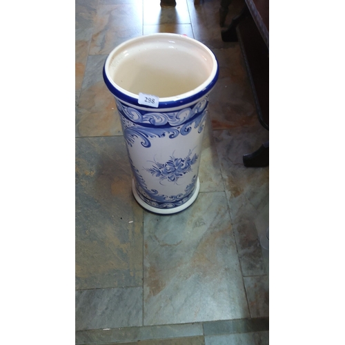 298 - Large blue and white ceramic umbrella stand featuring intricate floral and scroll designs.