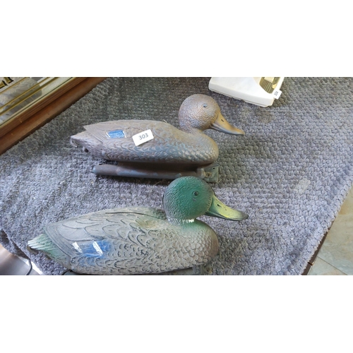 303 - Pair of vintage plastic duck decoys with detailed feathering and realistic coloring.