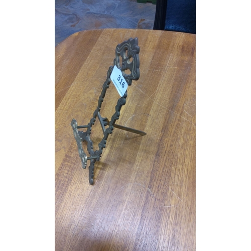 316 - Ornate brass easel stand with intricate scrollwork design. Period unknown.