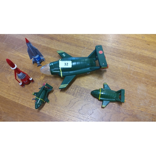 32 - Set of four Thunderbirds toy rockets, including Thunderbird 1, 2, and 3. The rockets feature detaile... 