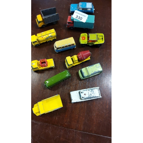 330 - Lot of 12 vintage die-cast toy vehicles including trucks, vans, and buses. Various colors and styles... 