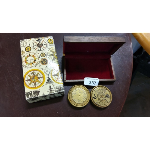 337 - Pair of brass perpetual calendars (1988-2037) in a lined wooden box with a compass-themed outer slee... 