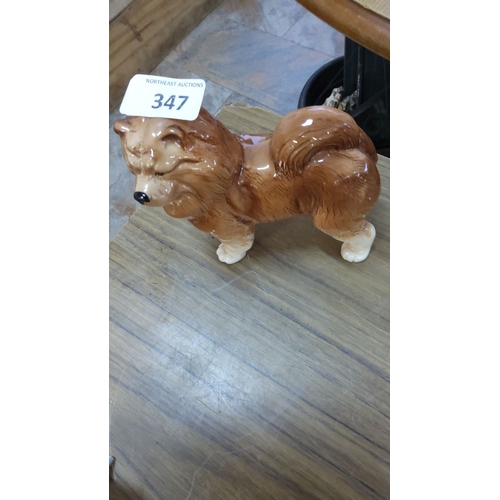 347 - Ceramic figurine of a brown dog with a curled tail. Glazed finish. Approximate dimensions: 6 inches ... 