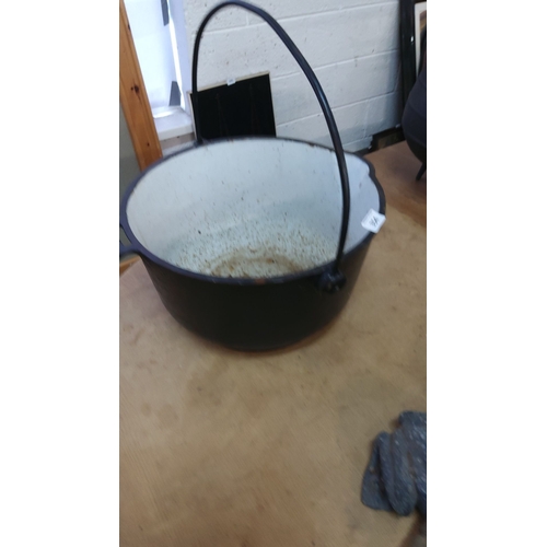 354 - Cast iron cauldron with white enameled interior and black exterior. Features a sturdy swinging handl... 