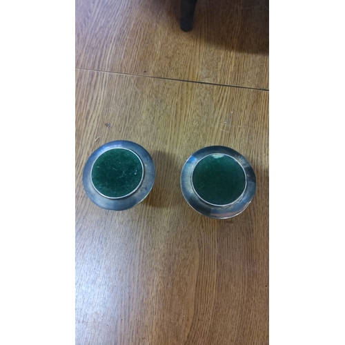 357 - Pair of silver-plated candlestick holders with green felt bases.