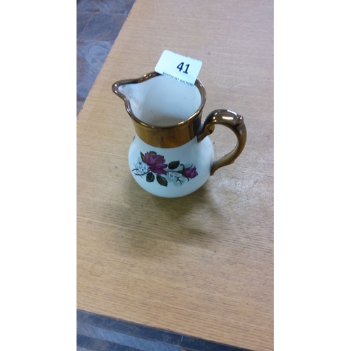 41 - Ceramic wade jug with floral design and gold accents. Marked at the base.