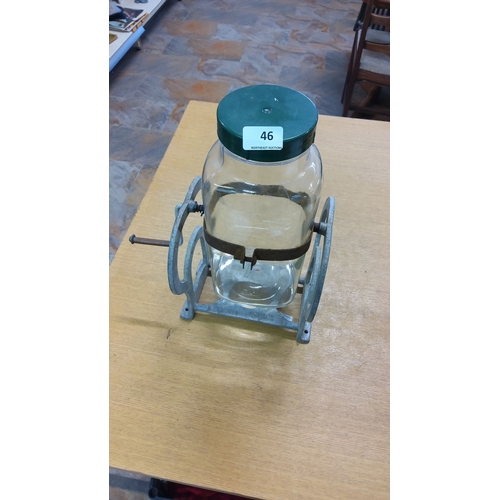 46 - Vintage glass butter churn with metal hand crank mechanism, featuring a green lid and sturdy metal b... 