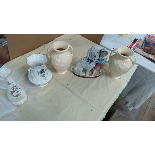 48 - Four porcelain items: two cream twin-handled vases with floral design, one white and blue floral pit... 