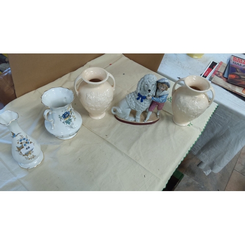 48 - Four porcelain items: two cream twin-handled vases with floral design, one white and blue floral pit... 