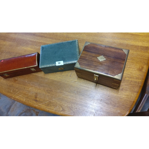 50 - Set of three vintage wooden and leather boxes, featuring brass accents and velvet-lined interiors.