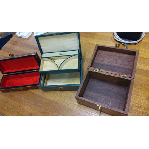 50 - Set of three vintage wooden and leather boxes, featuring brass accents and velvet-lined interiors.