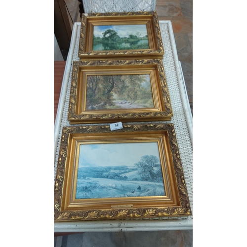 52 - Set of three framed landscape paintings, each depicting serene countryside scenes. Ornate gold frame... 