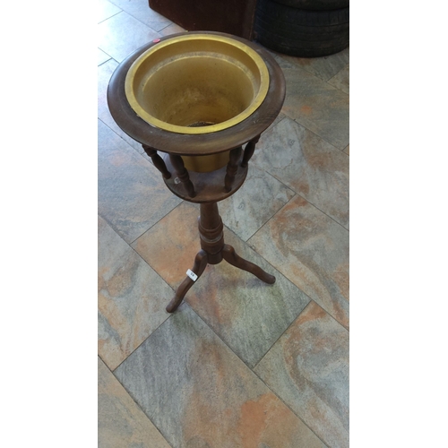 53 - Vintage wooden pedestal planter stand with brass insert, featuring a turned central column and tripo... 