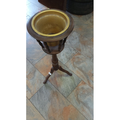 53 - Vintage wooden pedestal planter stand with brass insert, featuring a turned central column and tripo... 