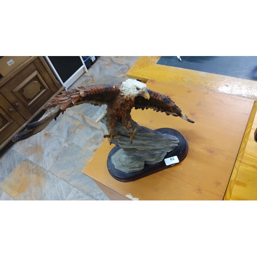 61 - Handcrafted eagle sculpture on a rocky base. Detailed wings and realistic texture. Crafted from mixe... 