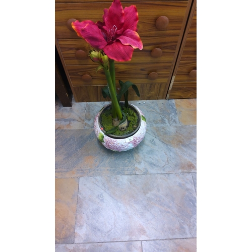 72 - Artificial flower arrangement in a decorative ceramic pot. Features vibrant red blooms and green fol... 