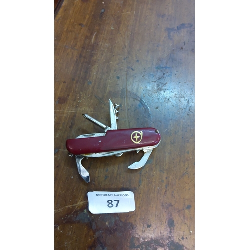 87 - Multi-tool pocket knife with a red handle. Comes with multiple stainless steel tools. These tools in... 