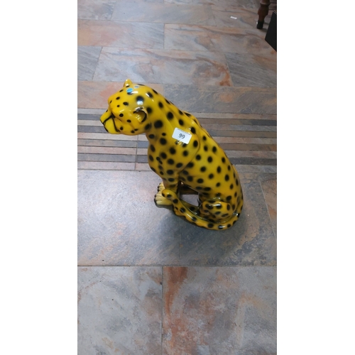 99 - Hand-painted ceramic cheetah figurine with vibrant yellow and black spots. It has realistic detailin... 