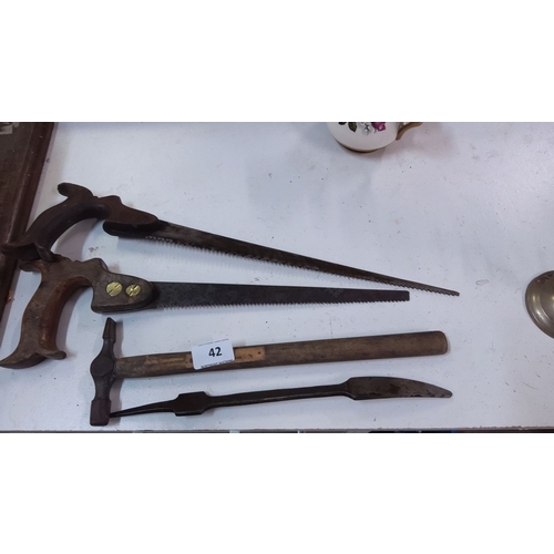 42 - Set of vintage hand tools. Includes two hand saws with wooden handles, a hammer with a wooden handle... 