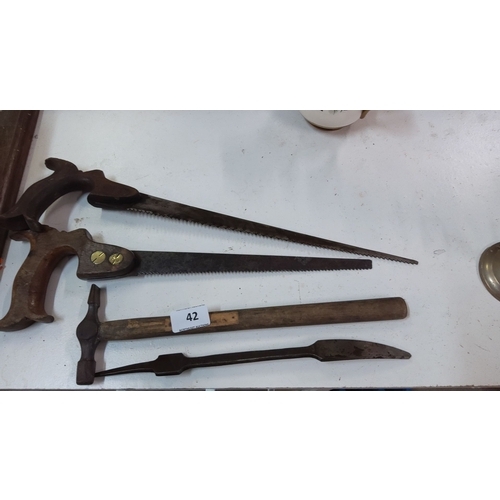 42 - Set of vintage hand tools. Includes two hand saws with wooden handles, a hammer with a wooden handle... 