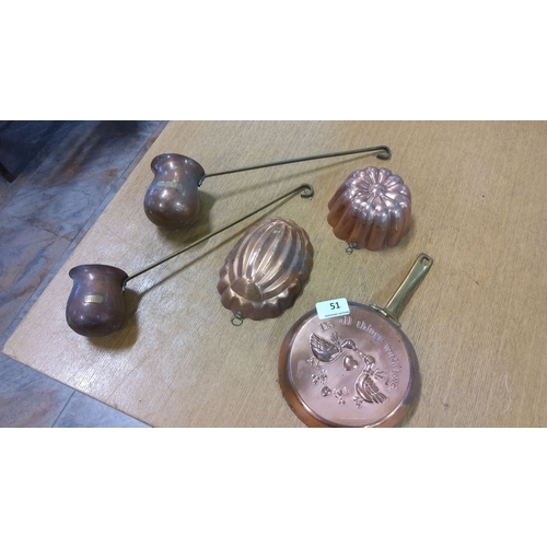 51 - Set of five vintage copper kitchen molds and ladles with brass handles, featuring various decorative... 