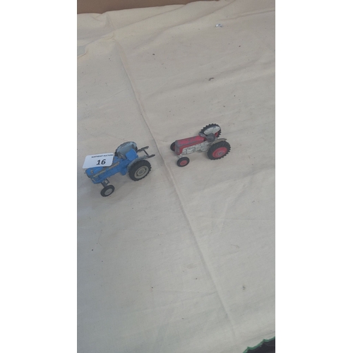 16 - Pair of vintage die-cast toy tractors, one blue and one red. Detailed construction and rubber wheels... 