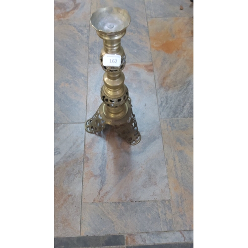 162 - Brass candle holder with intricate cut-out design, standing on a tripod base. Height approximately 1... 