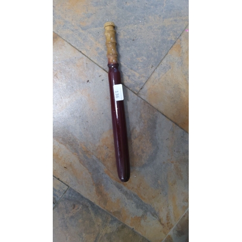 136 - Antique wooden baton with a red lacquered finish and a turned handle.