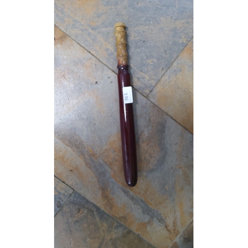 136 - Antique wooden baton with a red lacquered finish and a turned handle.