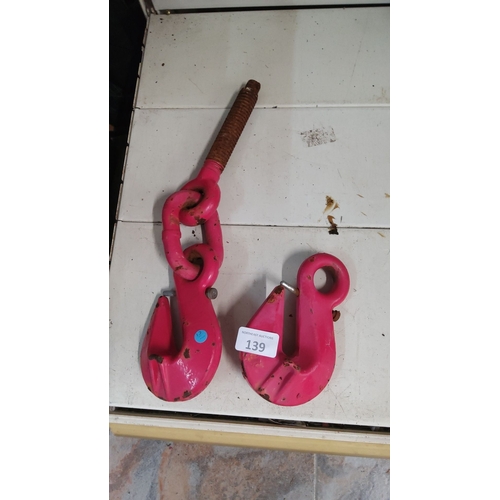 139 - Pair of heavy-duty red industrial hooks with threaded rod attachment. Rugged construction.