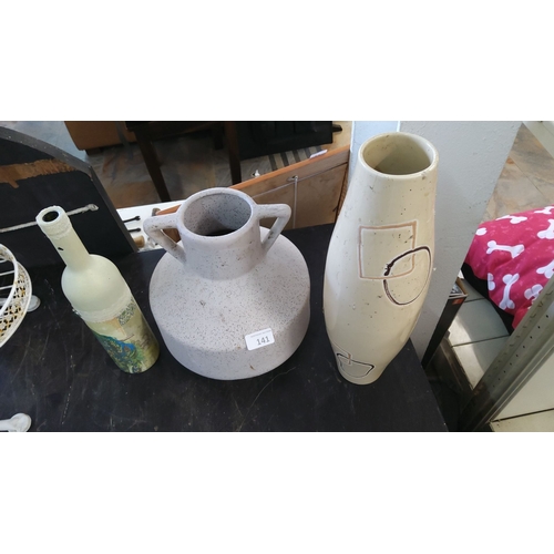 141 - Three decorative vases including one embellished bottle, a speckled two-handled jug, and a tall vase... 